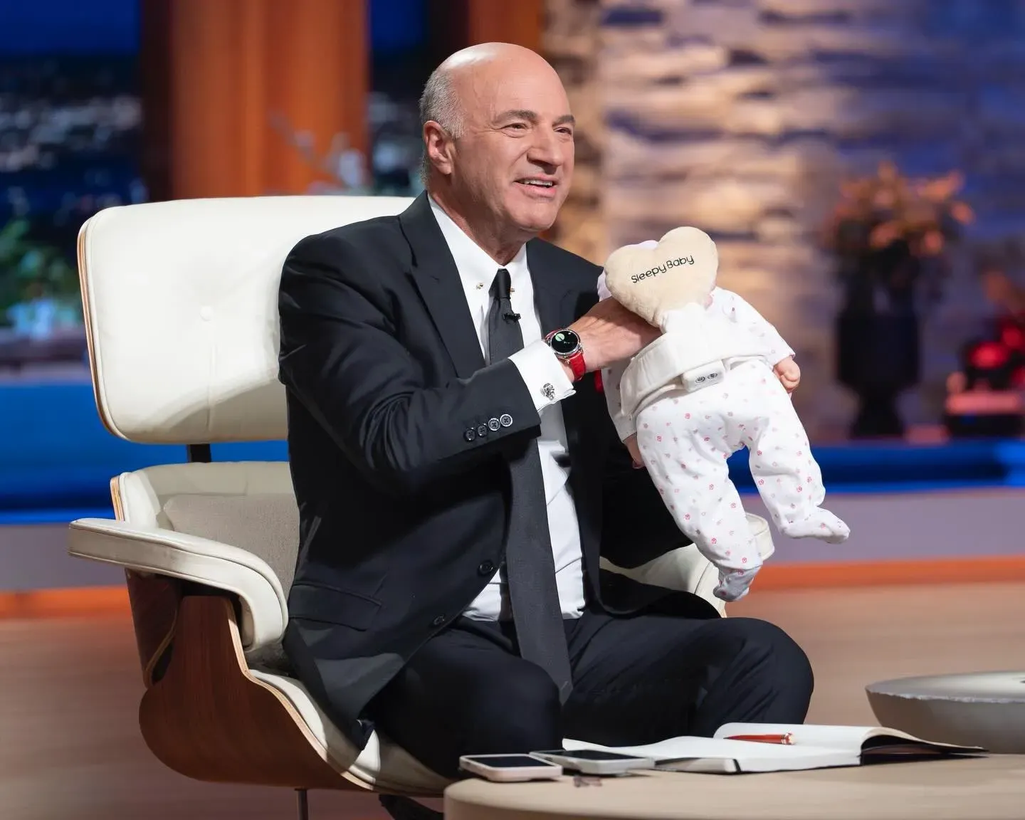 Kevin O’Leary examines the Sleepy Baby soothing device during the Shark Tank Season 17 pitch